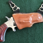 gun in a holster hanging from a garter